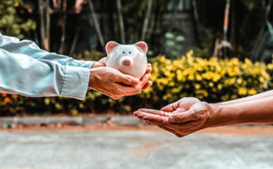 a person holding a piggy bank